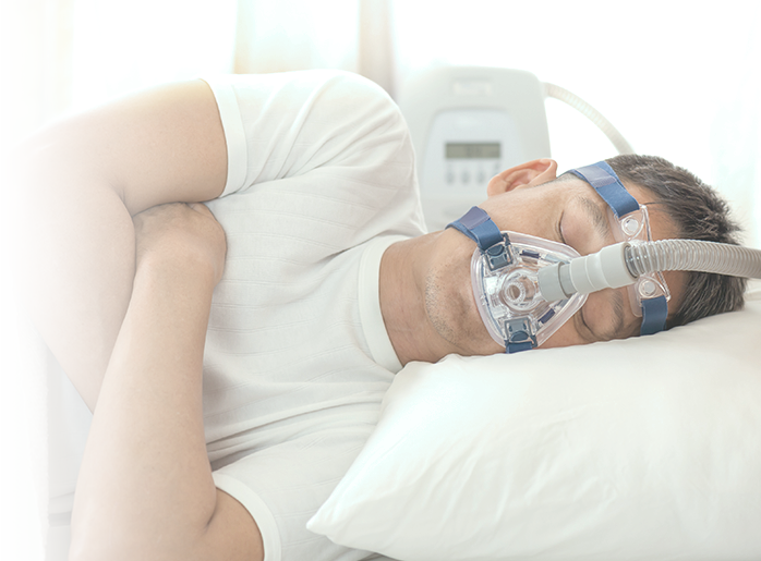 Man sleeping with CPAP machine