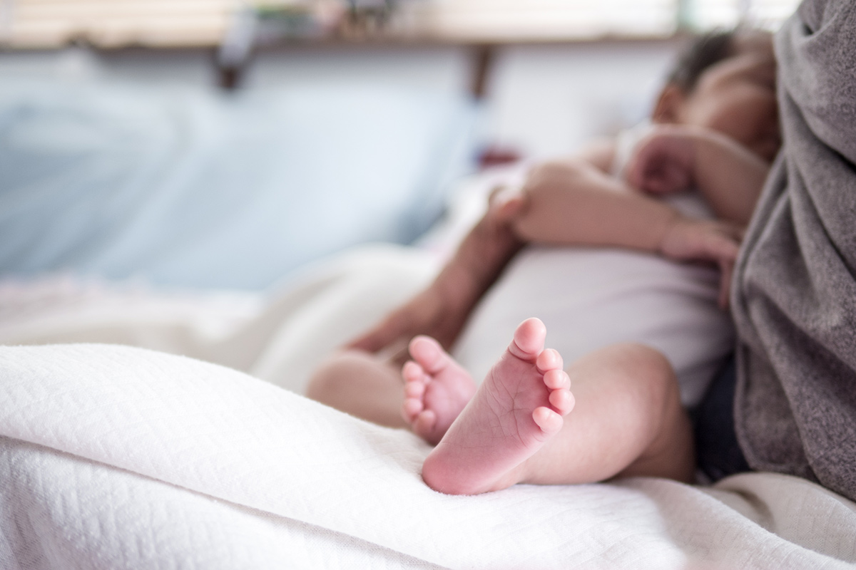 Newborn baby being breastfed